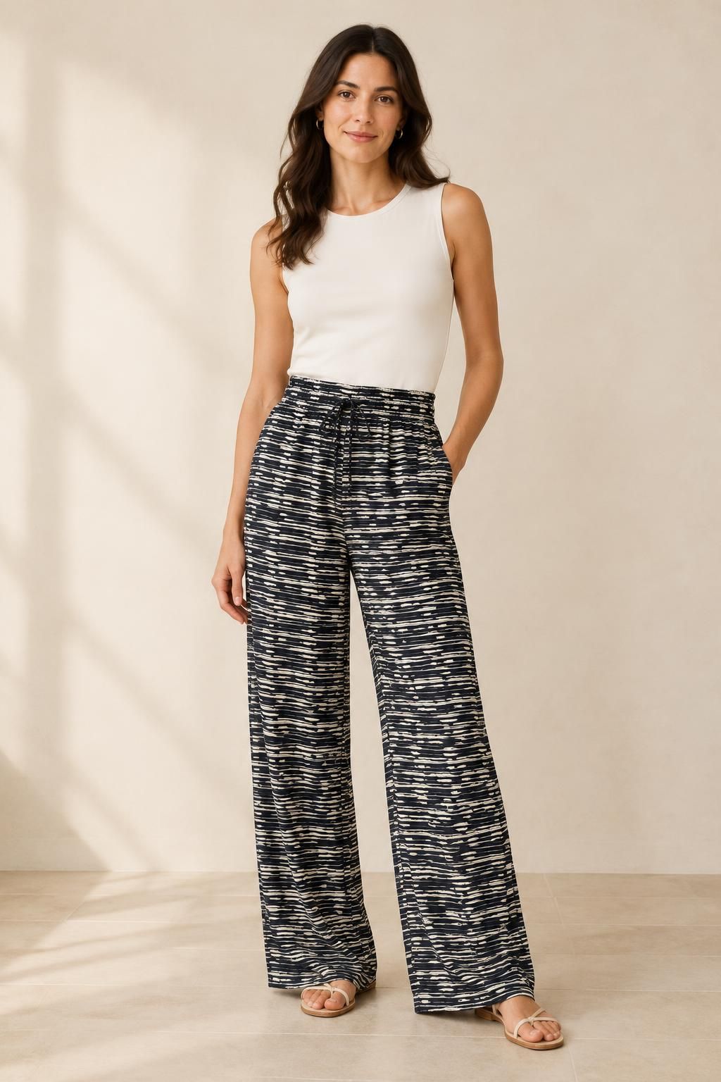 The trousers inspiration using Fluid viscose with graphic black and ecru stripes fabric